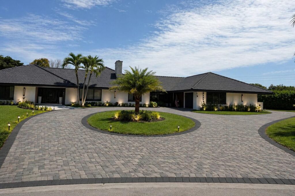 Painted stucco elevations on South Florida houses photographed on Elbaz Construction project sites: single and two-storey rendered walls with barrel-tile and flat roofs
