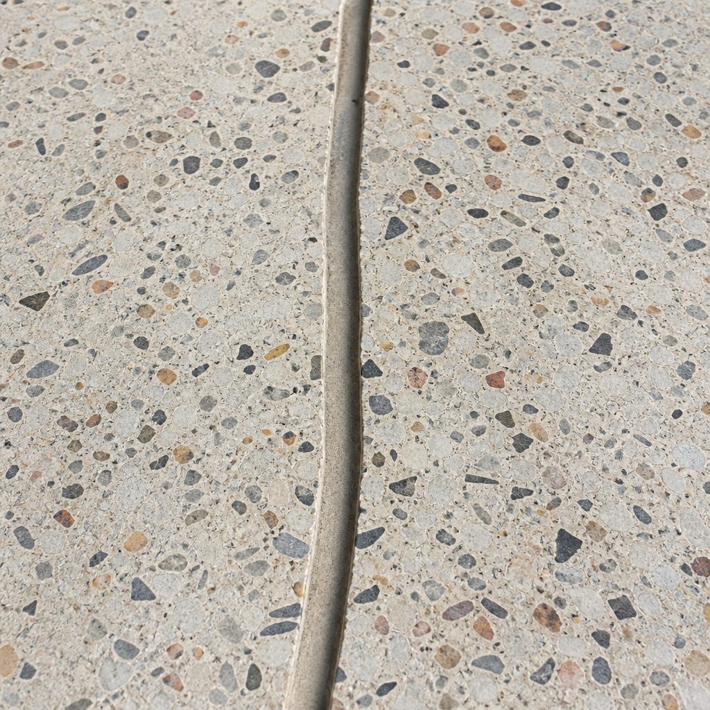 AI-generated illustration: a crack in a terrazzo floor routed out into a clean channel ready for filling