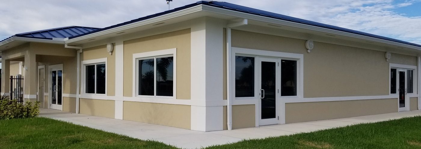 Low-slung home with replacement windows and a glazed entry door