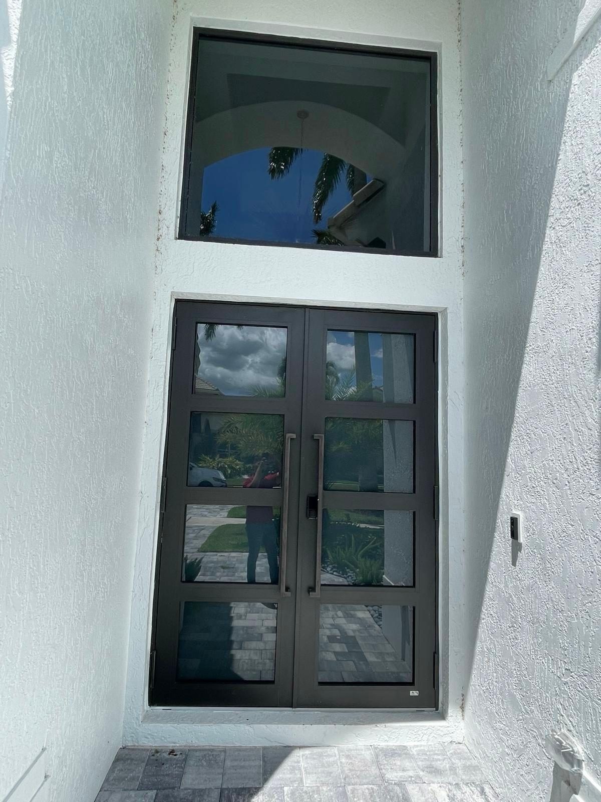 Arched window unit set into a stucco elevation