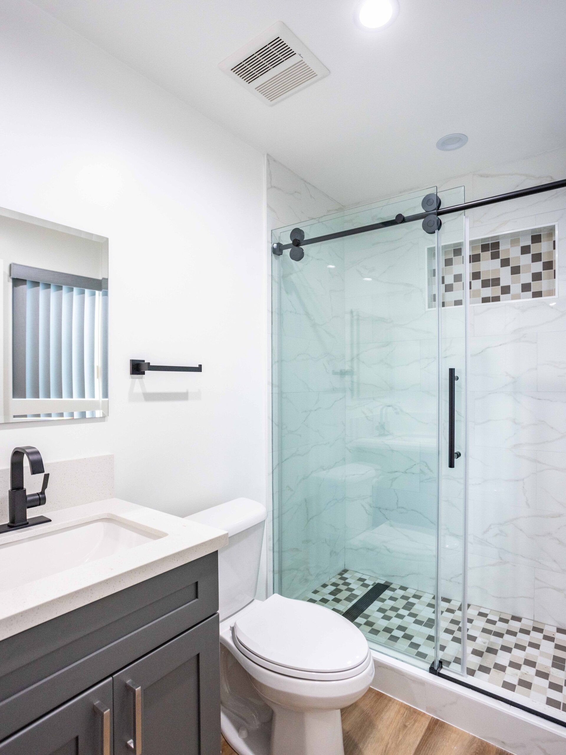 Full bathroom added in the converted garage, with shower, vanity and WC