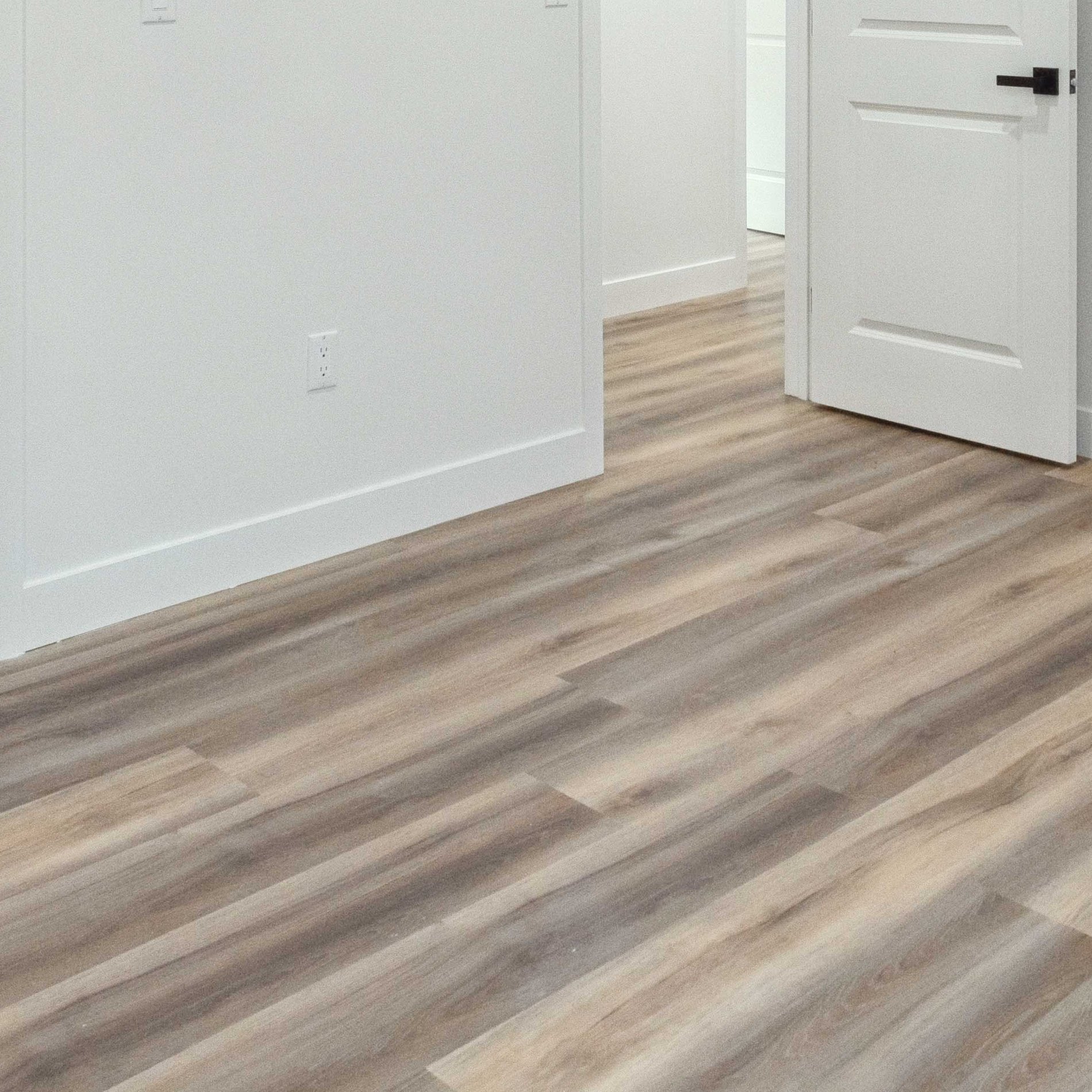 Level plank flooring running continuously through the converted garage interior