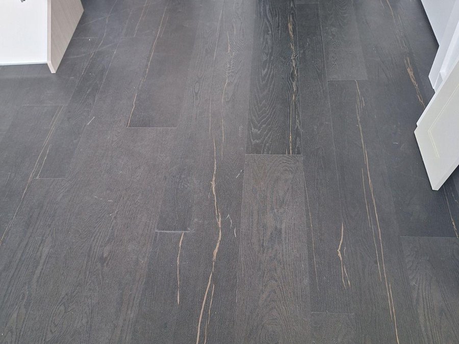 Dark-toned wood plank flooring in a completed South Florida interior