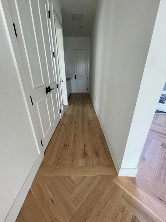 Wood plank flooring running along the length of a hallway