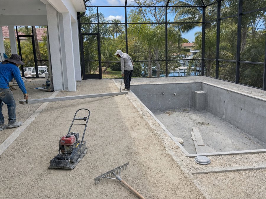Illustration of a compacted crushed-limerock base being levelled with a screed rail beside a pool shell