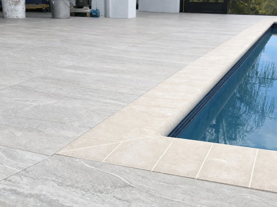 Illustration of the finished paver deck meeting the coping and the waterline tile