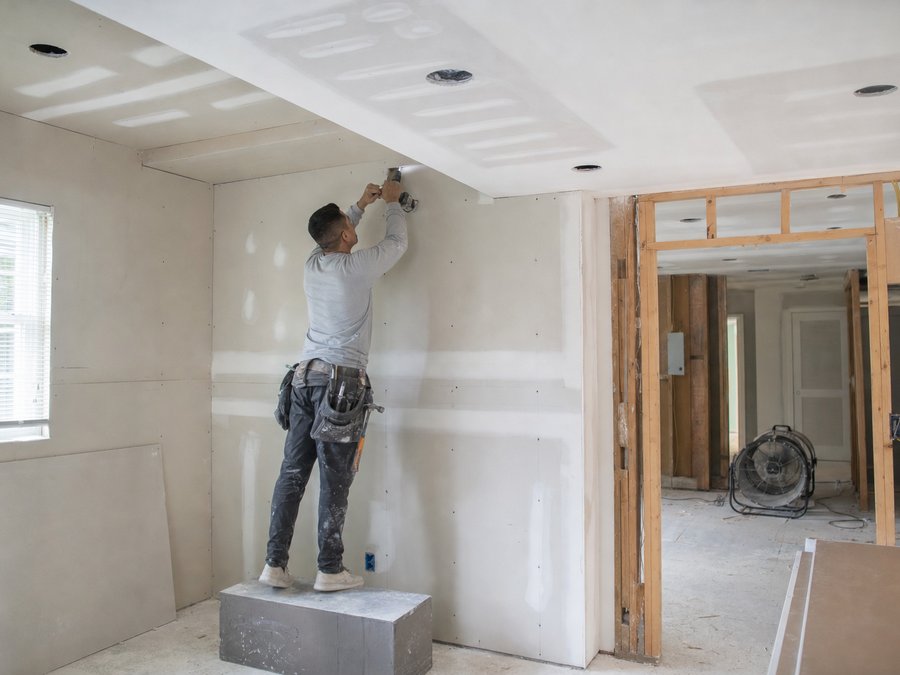 Illustration of new drywall being hung on studs in a room that has been dried out