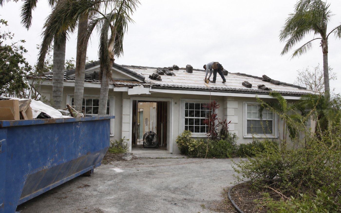 Illustration of a roofer replacing damaged sections of a shingle roof with new underlayment exposed