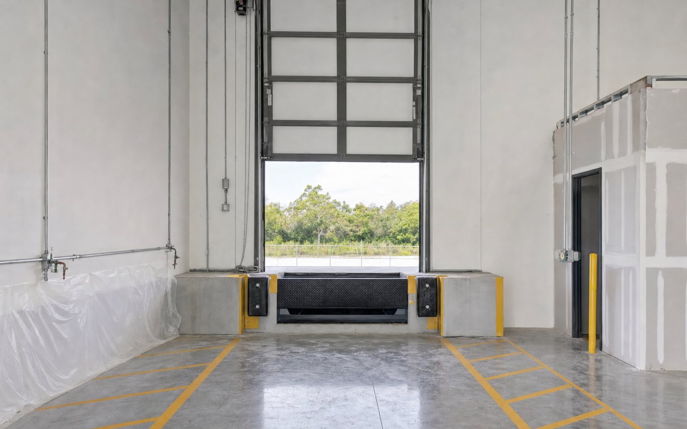 Illustration of a warehouse loading dock interior with a leveller, bumpers and sectional door
